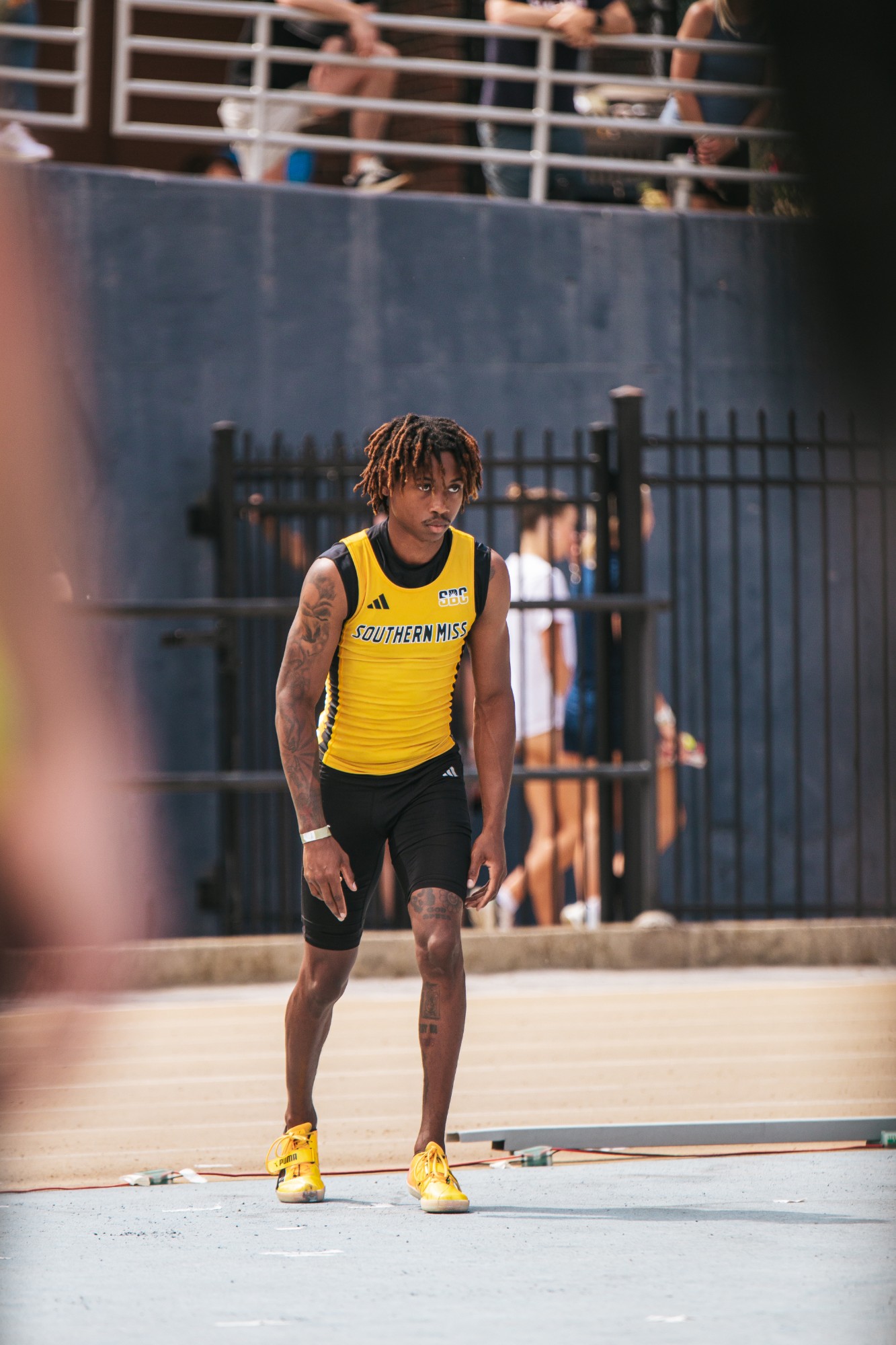 Tyler in a Southern Miss singlet on the track, focused before an event